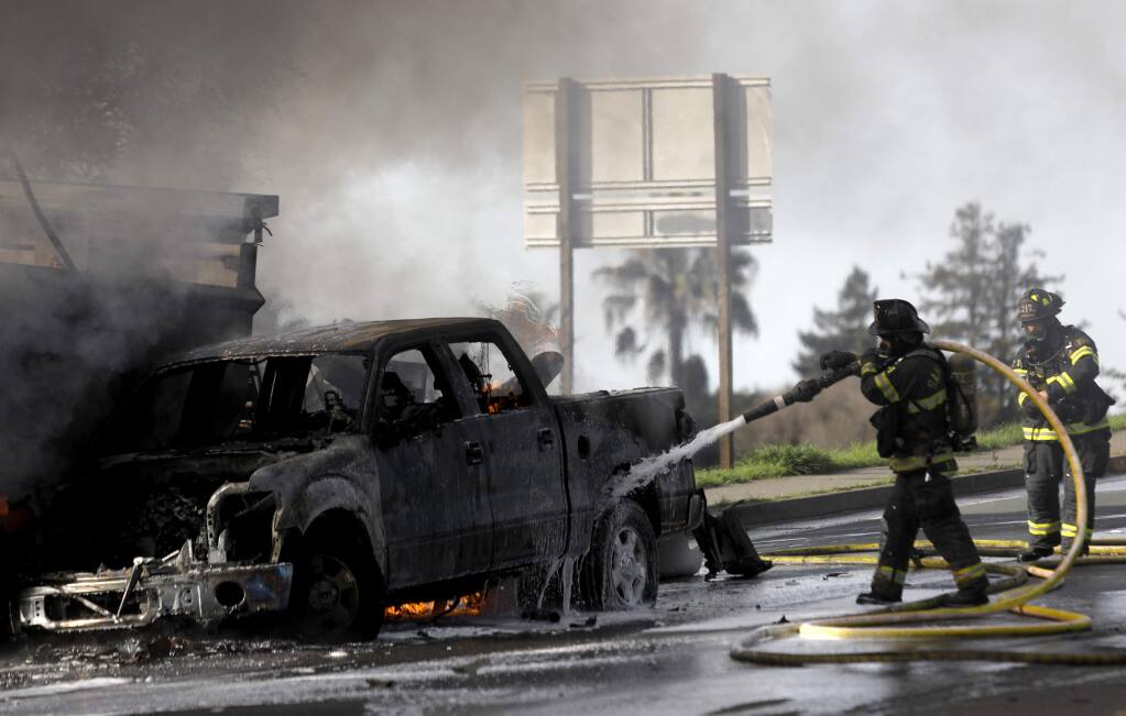 Firefighters work to put out a multivehicle fire at Fountaingrove Parkway and Mendocino Avenue in Santa Rosa Feb. 5, 2018. (BETH SCHLANKER/ The Press Democrat)
