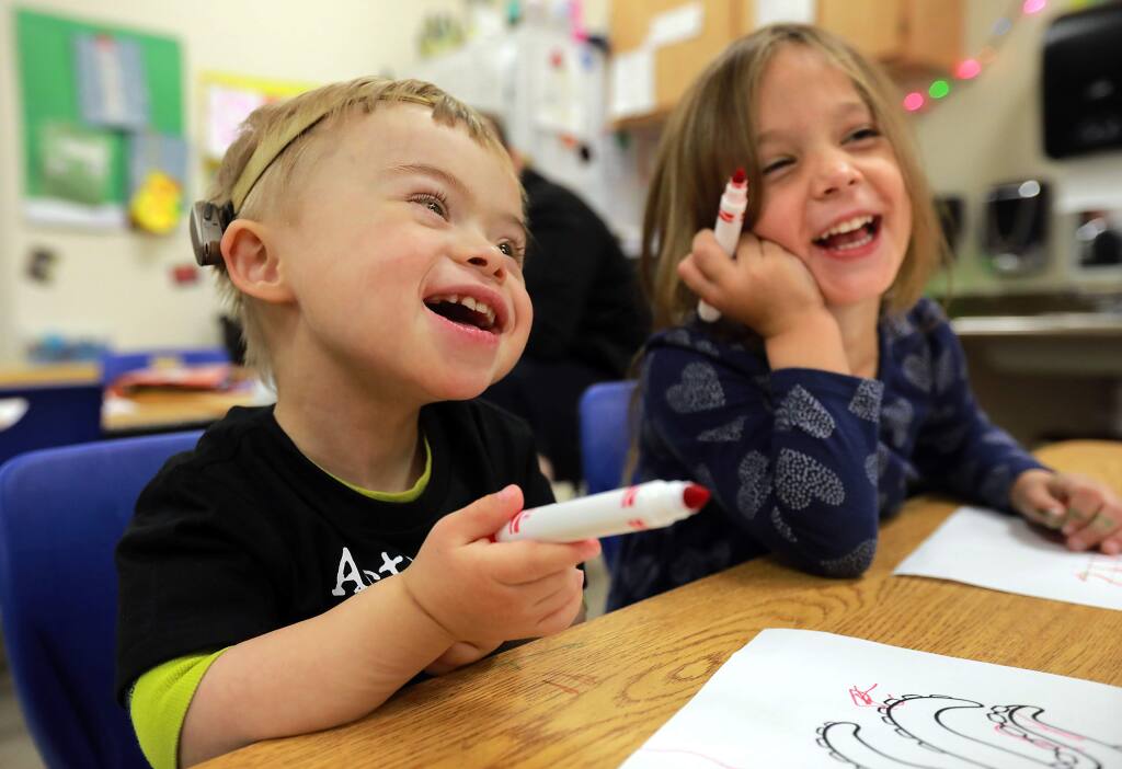 James O'Leary, 4, who was born with Down Syndrome, laughs with classmate Ella Ghidinelli, 3, at the Lattice School in Santa Rosa. (Photo by John Burgess/The Press Democrat)