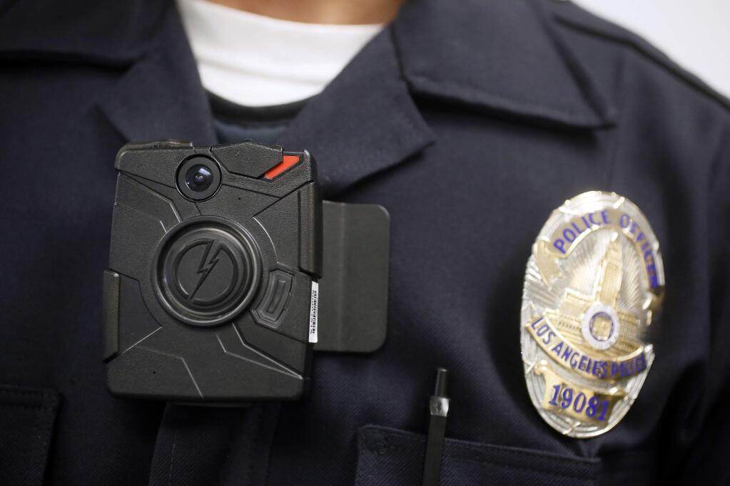 FILE - In this Jan. 15, 2014 file photo, a Los Angeles police officer demonstrates the use of a body camera. (AP Photo/Damian Dovarganes, File)