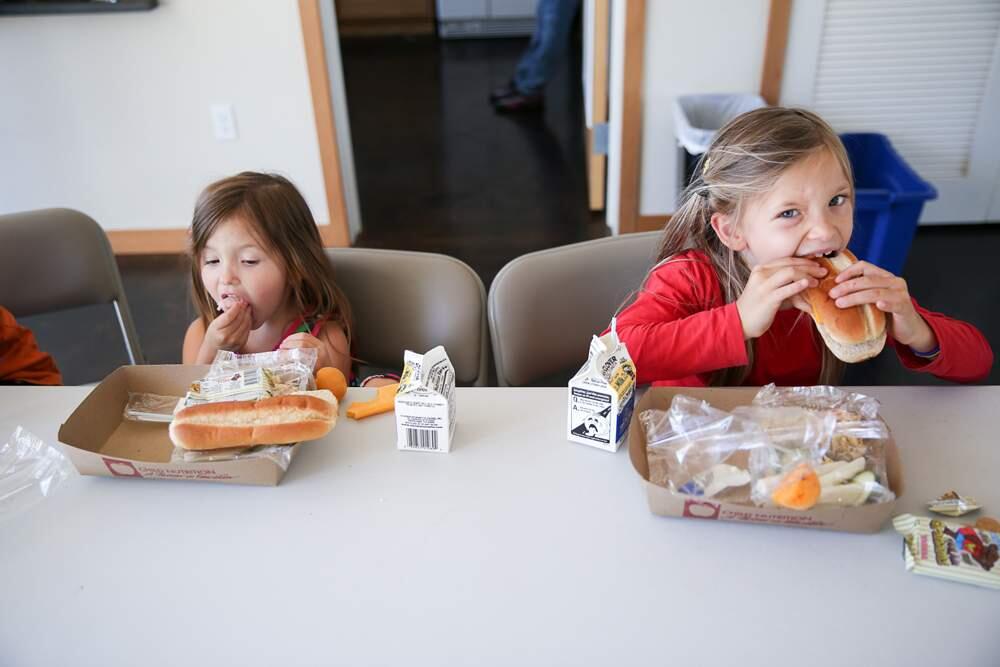 Alina Ruys, 3, and Cadence, 5, Ruys dig in to their meals at the free lunch program at Logan's Place on Friday, June 6, 2014.