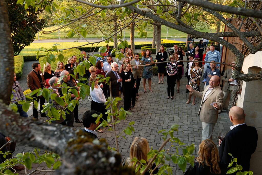 United Way of the Wine Country president and CEO Mike Kallhoff, at right, welcomes guests and makes opening remarks during Reading Between the Vines, a fundraiser for United Way of the Wine Country's education initiatives, at Jordan Vineyard and Winery in Healdsburg, California, on Friday, March 31, 2017. (Alvin Jornada / The Press Democrat)