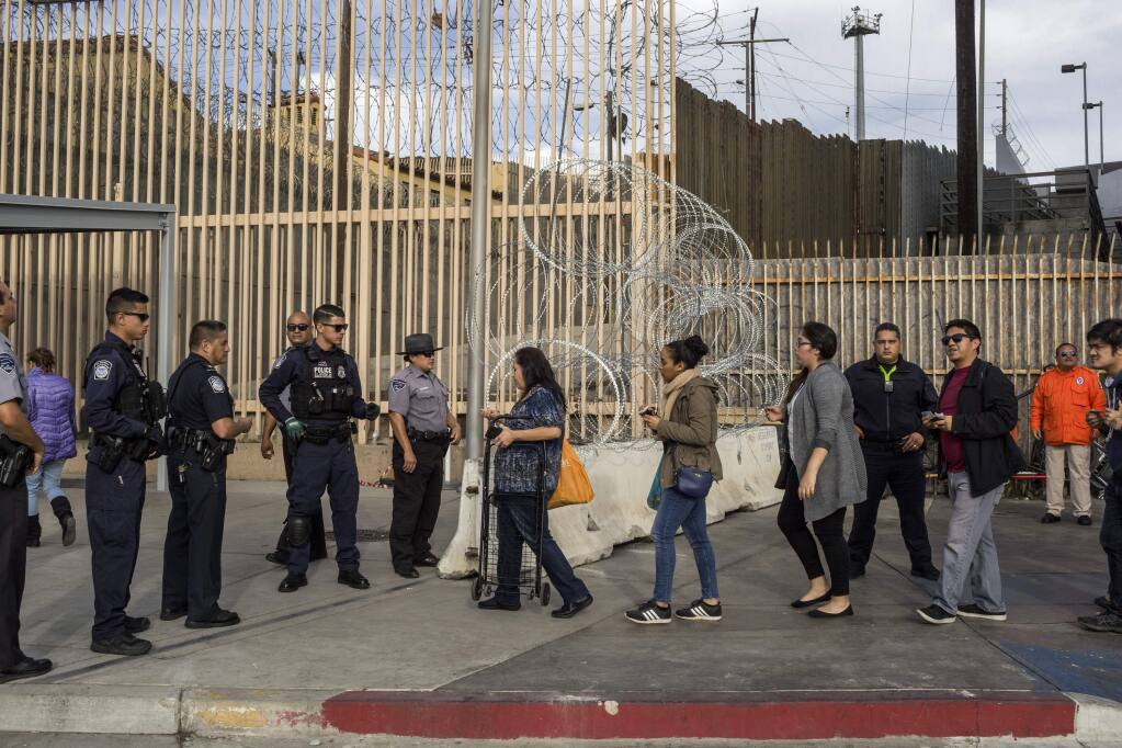 Pedestrians present their documents to U.S. Customs and Border Protection agents at the San Ysidro border crossing. (MAURICIO LIMA / New York Times, 2018)