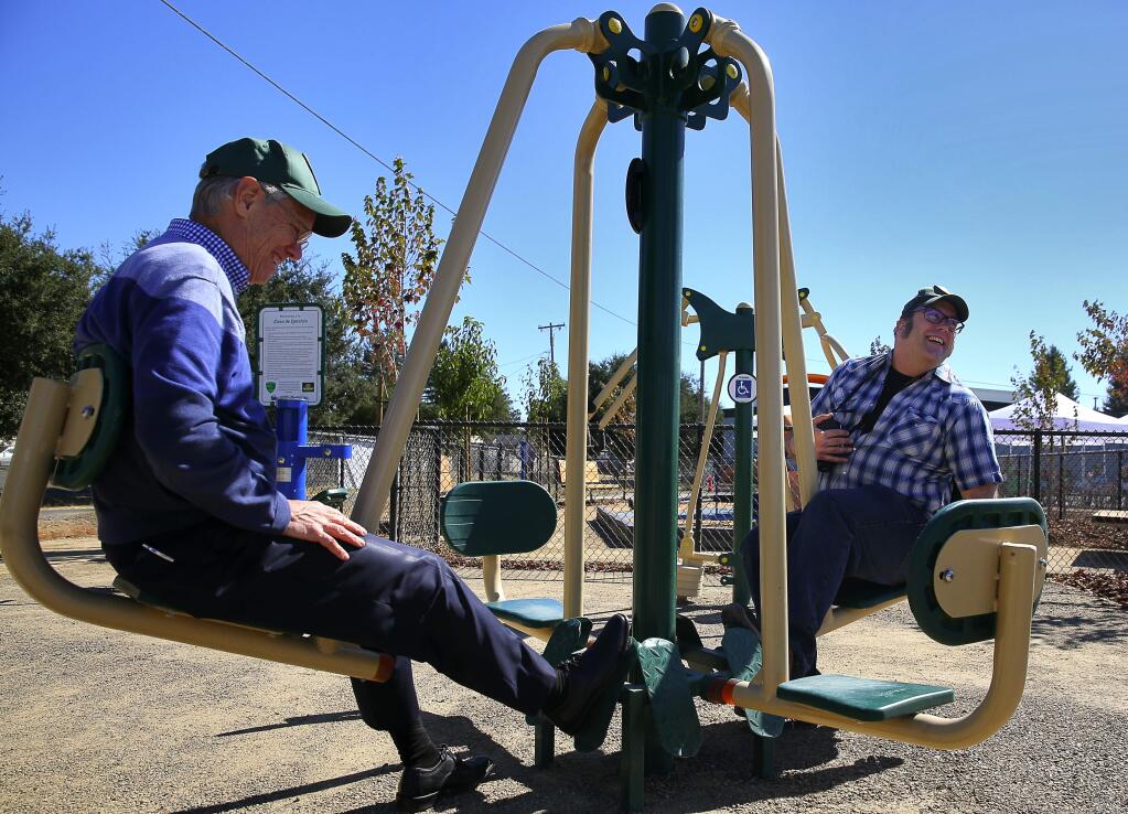 Jim Nantell, left, deputy director of Sonoma County Regional Parks, and volunteer coordinator John Ryan try out some of the features at the Roseland Village Joe Rodota Trail Linear Park before the dedication ceremony, in Santa Rosa, on Wednesday, August 31, 2016. (Christopher Chung/ The Press Democrat)
