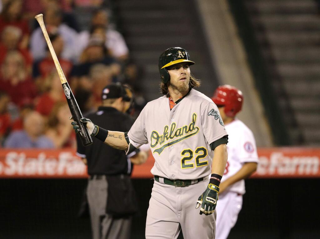 Oakland Athletics' Josh Reddick walks off the field after striking out during the fourth inning of a baseball game against the Los Angeles Angels, Tuesday, Sept. 29, 2015, in Anaheim, Calif. (AP Photo/Jae C. Hong)