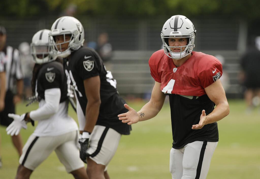 Oakland Raiders quarterback Derek Carr gestures during practice Wednesday, Aug. 8, 2018, in Napa. Both the Oakland Raiders and the Detroit Lions held a joint practice before their upcoming preseason game on Friday. (AP Photo/Eric Risberg)