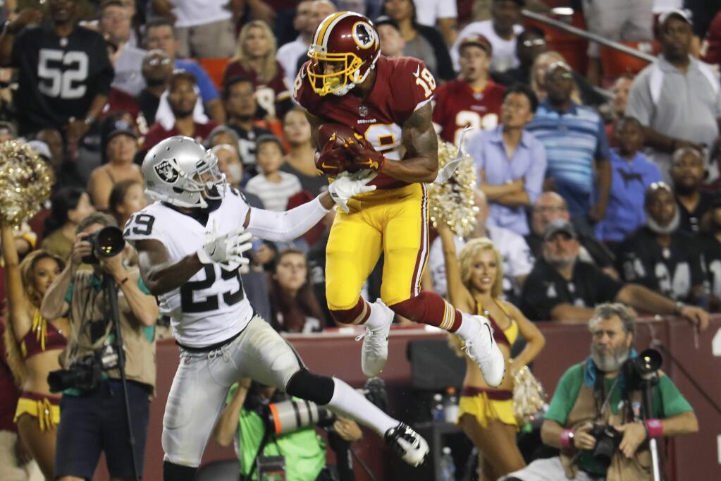Washington Redskins wide receiver Josh Doctson pulls in a touchdown pass as Oakland Raiders cornerback David Amerson looks back at him during the second half in Landover, Md., Sunday, Sept. 24, 2017. (AP Photo/Pablo Martinez Monsivais)