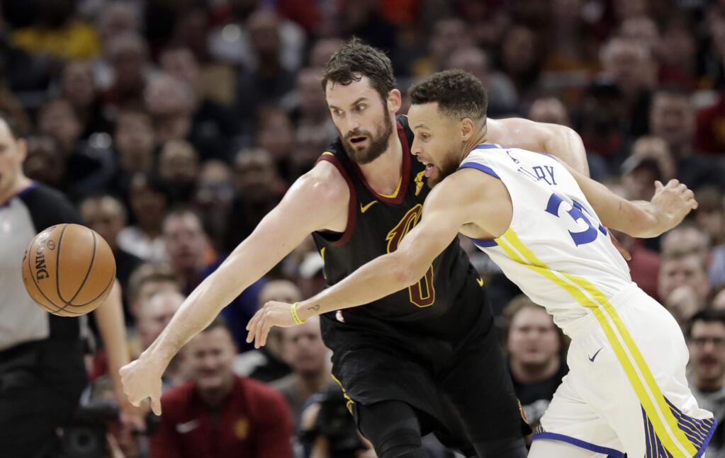 Cleveland Cavaliers' Kevin Love, left, and Golden State Warriors' Stephen Curry battle for the ball in the first half of an NBA basketball game, Monday, Jan. 15, 2018, in Cleveland. (AP Photo/Tony Dejak)
