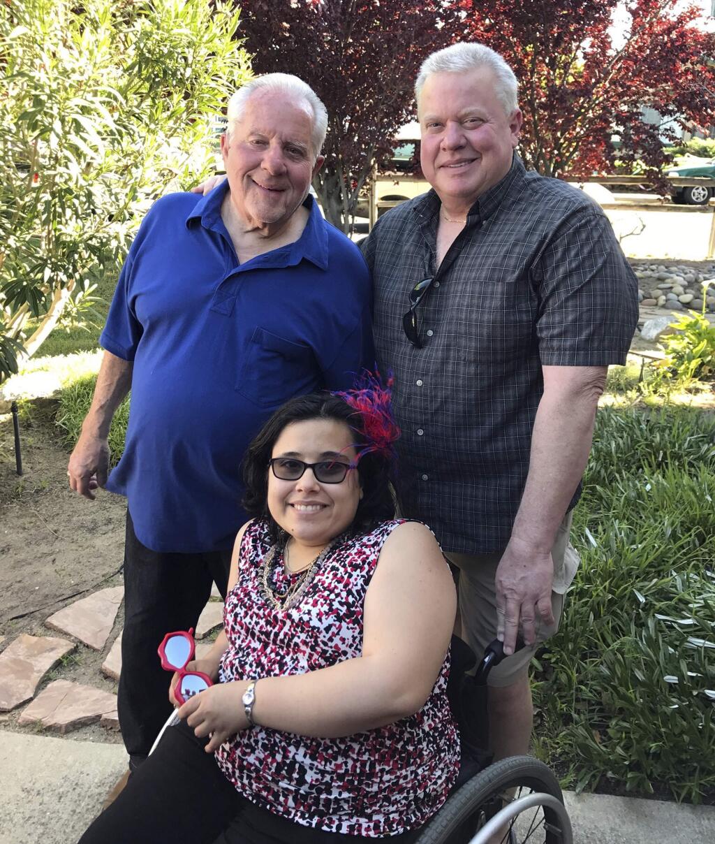 This April, 2017 photo shows Christina Hanson, with her grandfather Dick Hanson, left, and her father Michael Hanson, in Oakley, Calif. Christina Hanson, 27, died in the Tubbs fire in Santa Rosa and Michael Hanson was severely burned . (Brittney Vinculado via AP)