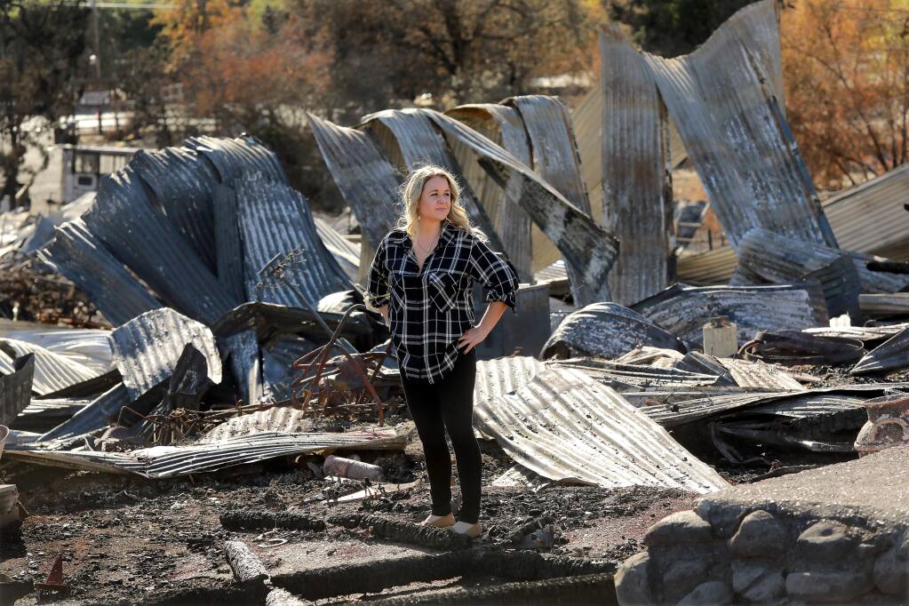 Third generation Cloverleaf Ranch owner Shawna DeGrange stands in the remains of one of the two barns from the 1860's that were lost in the Tubbs Fire. Grange hopes to have the equestrian camp the family has operated for 70 years open by next summer. (photo by John Burgess/The Press Democrat)