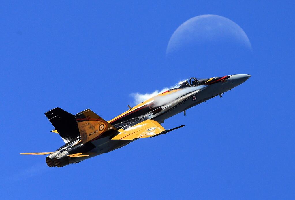 The Royal Canadian Air Force CF-18 Hornet piloted by Capt. Ryan Kean flies by the moon at the Wings Over the Wine Country Airshow at the Charles M. Schulz-Sonoma County Airport on Saturday. (John Burgess/The Press Democrat)