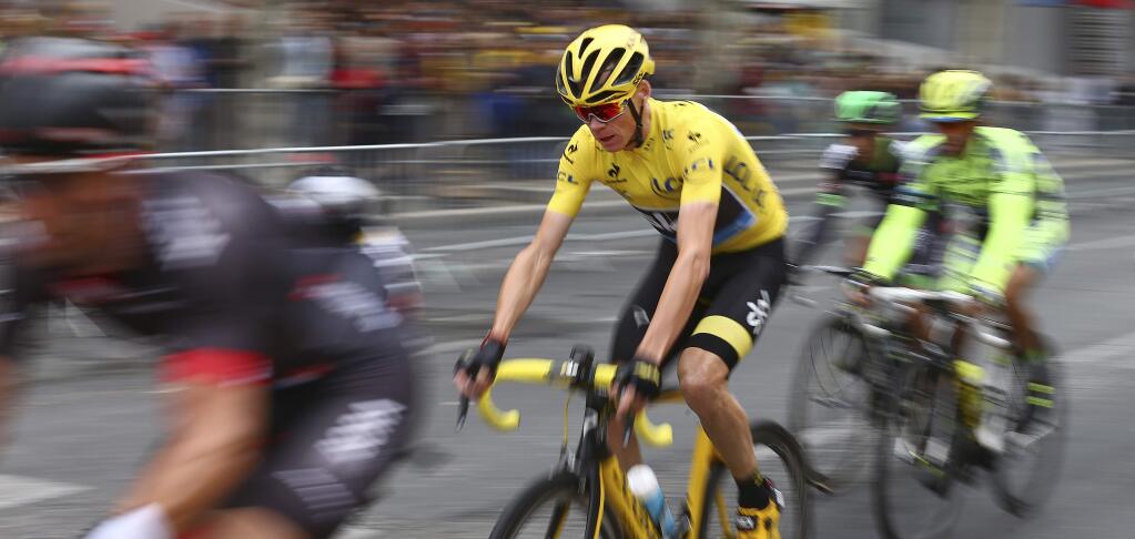 Britain's Chris Froome, wearing the overall leader's yellow jersey, rides on the Champs Elysees avenue during the twenty-first and last stage of the Tour de France cycling race over 109.5 kilometers (68 miles) with start in Sevres and finish in Paris, France, Sunday, July 26, 2015. (AP Photo/Laurent Rebours)