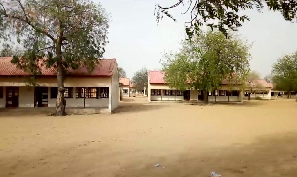 FILE - This image taken from video on Thursday Feb. 22, 2018 shows the exterior of Government Girls Science and Technical College in Dapchi, Nigeria. Nigeria's security forces failed to respond to several warnings that suspected Boko Haram extremists were on their way to a town where 110 schoolgirls were abducted last month, rights group Amnesty International said Tuesday March 20, 2018. (AP Photo, File)