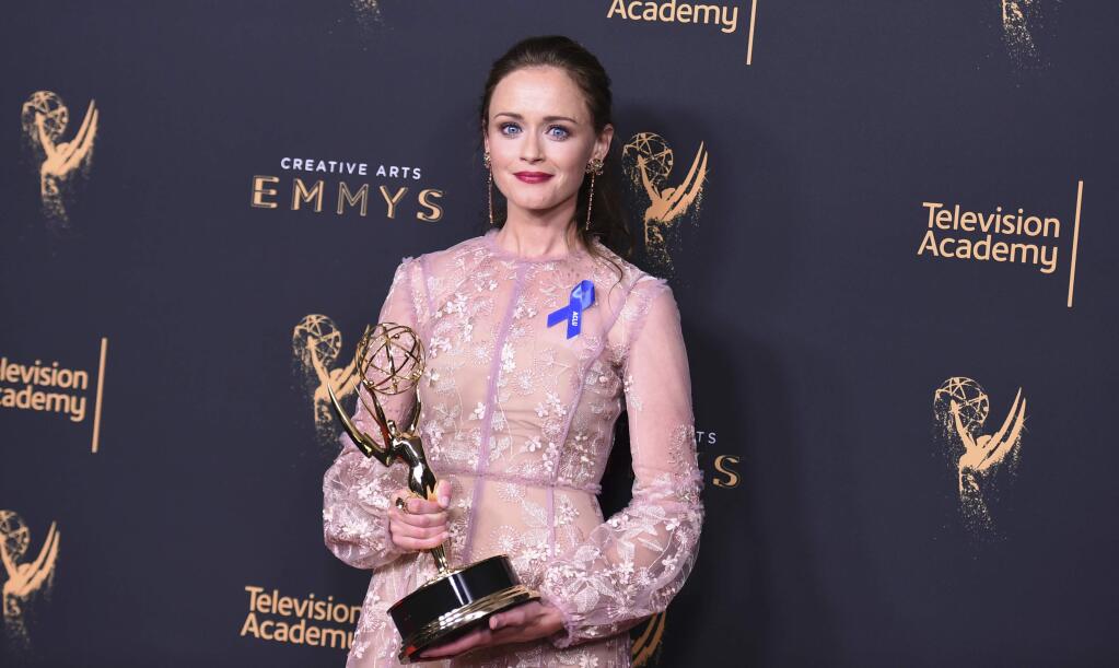 Alexis Bledel poses in the press room with the award for outstanding guest actress in a drama series for 'The Handmaid's Tale' during night two of the Creative Arts Emmy Awards at the Microsoft Theater on Sunday, Sept. 10, 2017, in Los Angeles. (Photo by Richard Shotwell/Invision/AP)