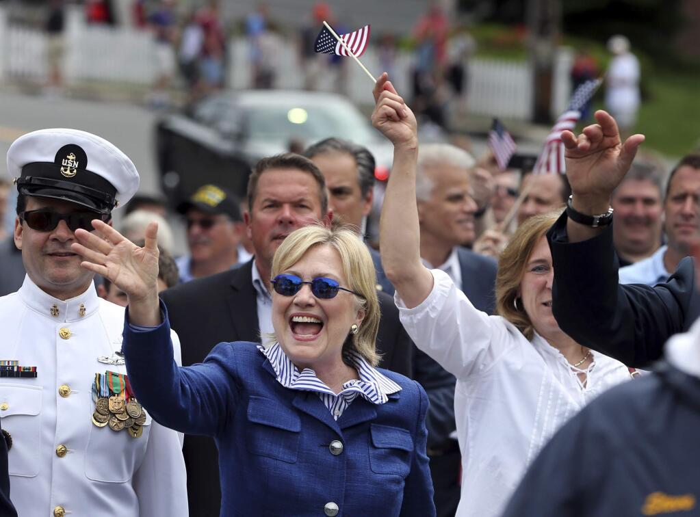 Democratic presidential candidate Hillary Clinton waves as she walks in a Memotial Day parade Monday, May 30, 2016, in Chappaqua, N.Y. (AP Photo/Mel Evans)