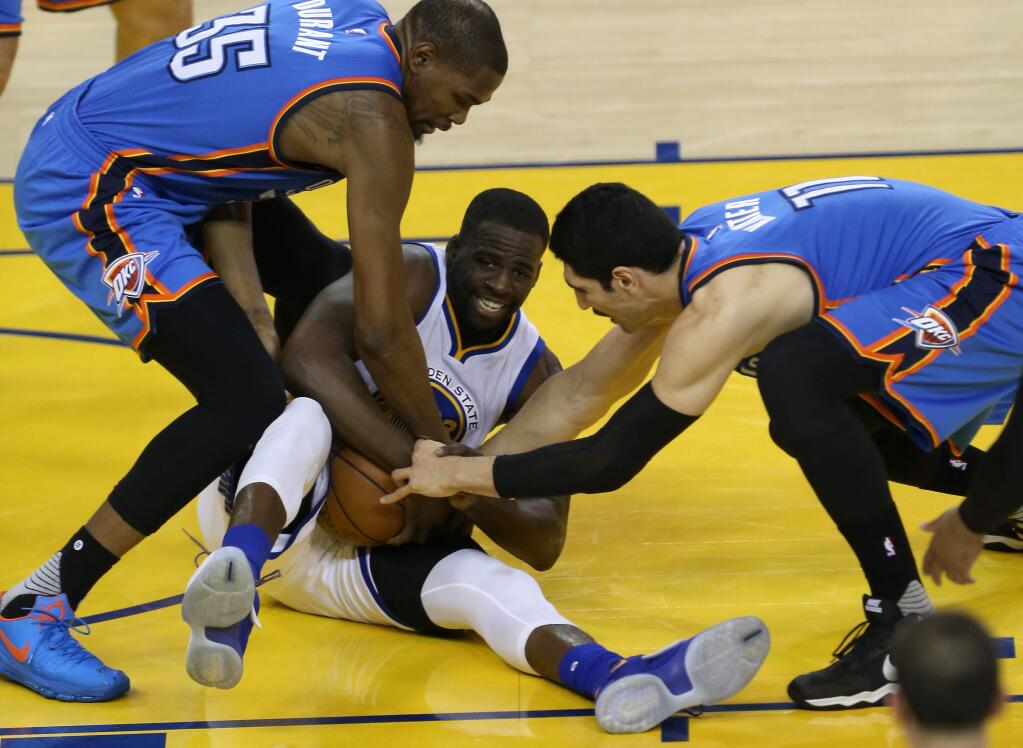 Golden State Warriors' Draymond Green is tied up for a jump ball against Oklahoma City Thunder's Kevin Durant and Enes Kanter, during their game in Oakland on Wednesday, May 18, 2016. The Warriors defeated the Thunder 118-91.(Christopher Chung/ The Press Democrat)