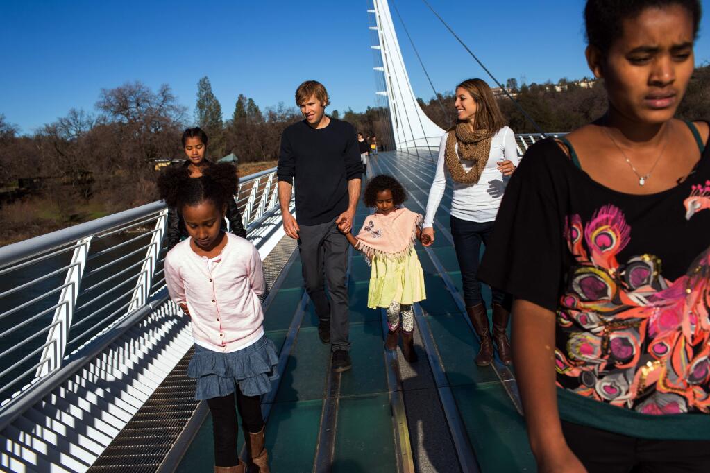 The Hall family, from left, Mia, Jasmine, Ryan, Lily, Sara, and Hana, cross the Sundial Bridge in Redding, Jan. 10, 2016. Ryan Hall, one of the last remaining hopes for an American frontrunner in this summer's Olympic marathon, is retiring, citing chronically low testosterone levels and extreme fatigue. (Elizabeth D. Herman/The New York Times)