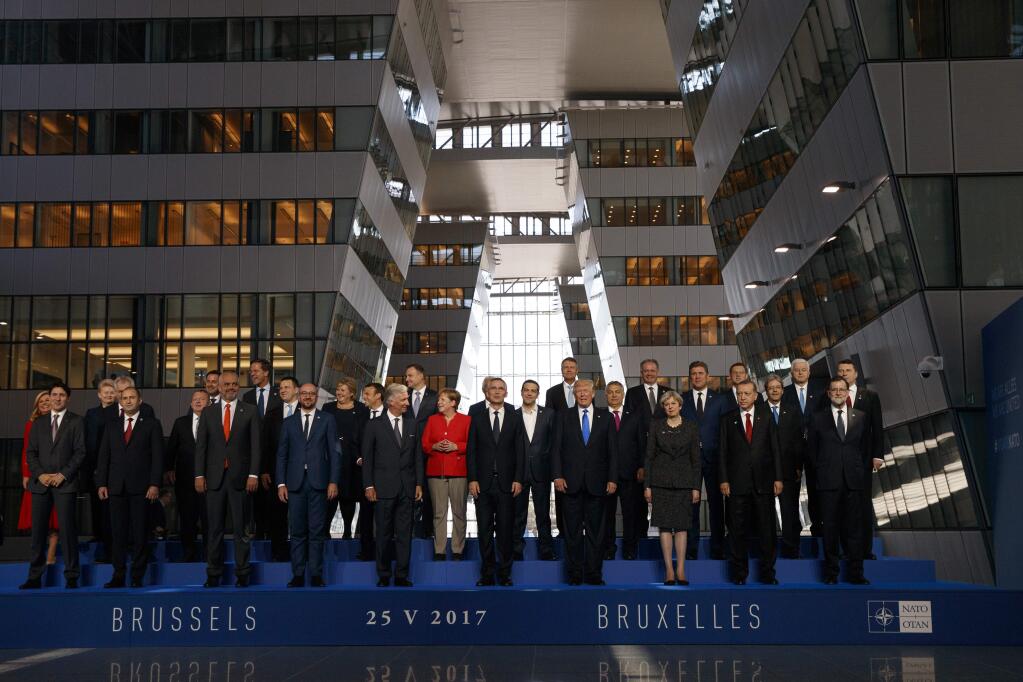 President Donald Trump poses with NATO leaders for a group photo at the new NATO headquarters, Thursday, May 25, 2017, in Brussels. (AP Photo/Evan Vucci)