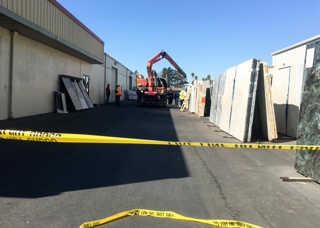 Cal-OSHA investigators study the scene where a man was crushed by granite slabs at Ceramic Tile Center in Santa Rosa, Thursday, Oct. 5, 2017. (NICK RAHAIM / PRESS DEMOCRAT)
