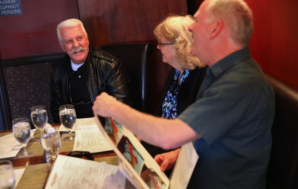 Larry Frederick, left, laughs with his wife, Gail Frederick, and Jim Fazackerley as they talk about Larry's near-fatal accident in 1982, during a reunion lunch in Santa Rosa on Monday, March 12, 2018. Frederick was an Oakland Police Officer performing a late night traffic stop, on Highway 17 near 5th Avenue, when he was struck by a vehicle. Fazackerley, along with Steve Stuart, were the first responders who transported him to the hospital.(Christopher Chung/ The Press Democrat)