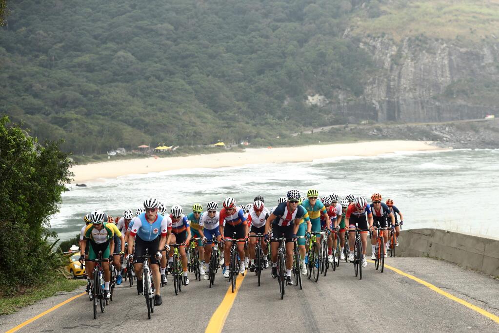 Cyclists ride along the coast during the women's cycling road race final at the 2016 Summer Olympics in Rio de Janeiro, Brazil, Sunday, Aug. 7, 2016. (Bryn Lennon/Pool Photo via AP)