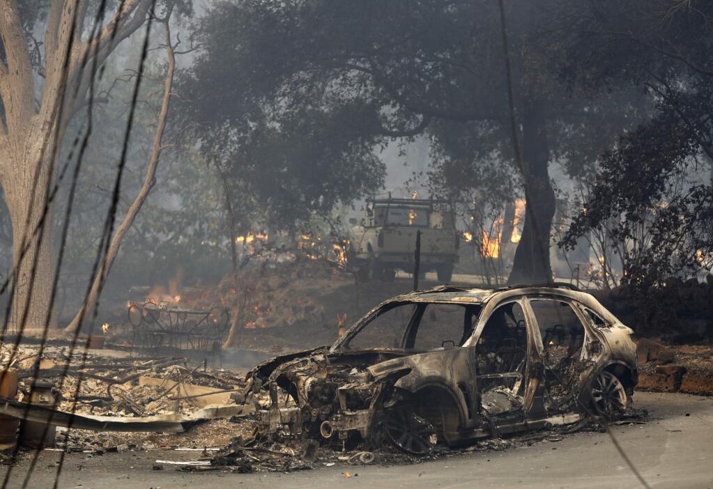 Homes and vehicles ravaged by fire on Warm Springs Road on Monday, Oct. 9, 2017, in Glen Ellen, California . (Beth Schlaner /The Press Democrat)