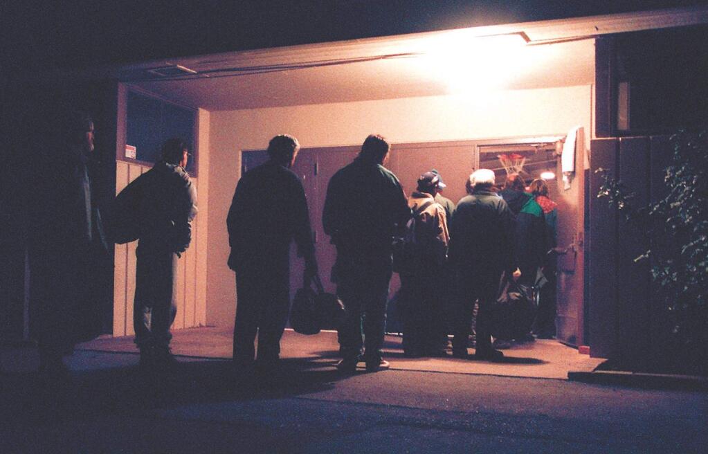 FILE - Homeless men line up to spend the night at the National Guard Armory in Santa Rosa on Tuesday, Feb. 2, 2002. (Christopher Chung / Press Democrat)
