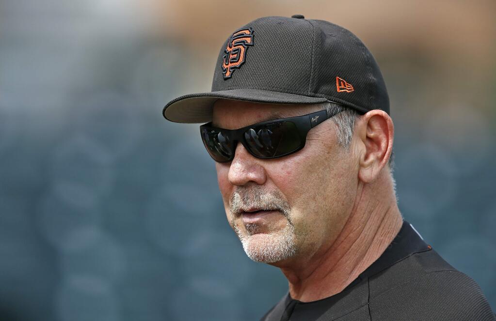 FILE - In this March 15, 2017, file photo, San Francisco Giants manager Bruce Bochy watches batting practice prior to a spring training baseball game against the Los Angeles Angels, in Scottsdale, Ariz. (AP Photo/Ross D. Franklin, File)