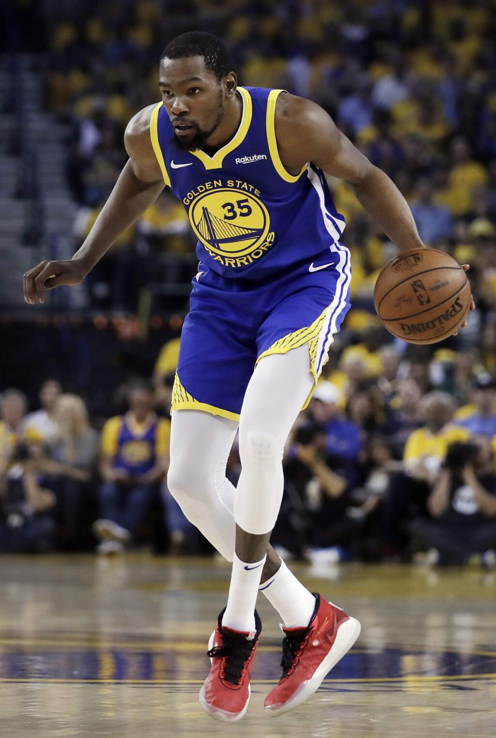 Golden State Warriors' Kevin Durant, right, drives the ball against Los Angeles Clippers' Lou Williams during the first half in Game 5 of a first-round NBA basketball playoff series, Wednesday, April 24, 2019, in Oakland, Calif. (AP Photo/Ben Margot)
