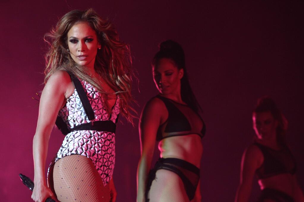 FILE - In this May 29, 2015, file photo, Jennifer Lopez performs on stage at Morocco's biggest music Mawazine Festival in Rabat, Morocco. Lopez is taking on hosting duties at the American Music Awards, on Nov. 22, 2015. Producers say Lopez will host and perform at the show, set to be broadcast live on ABC from the Microsoft Theater in Los Angeles. (AP Photo/Abdeljalil Bounhar, File)