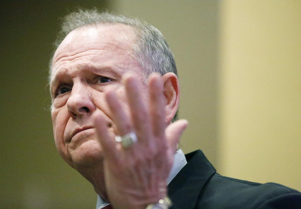 Former Alabama Chief Justice and U.S. Senate candidate Roy Moore speaks at the Vestavia Hills Public library, Saturday, Nov. 11, 2017, in Birmingham, Ala. According to a Thursday, Nov. 9 Washington Post story an Alabama woman said Moore made inappropriate advances and had sexual contact with her when she was 14. Moore has denied the allegations. (AP Photo/Brynn Anderson)