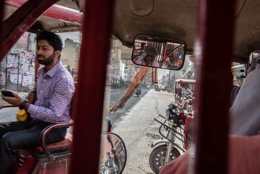A New Delhi street as seen from the front of an electric rickshaw, June 19, 2019. A million electric rickshaws sprang up out of nowhere and are now being used by 60 million people a day. The government and vehicle makers are struggling to catch up. (Saumya Khandelwal/The New York Times)
