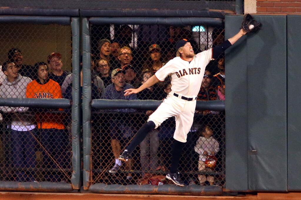 San Francisco Giants right fielder Hunter Pence grabs a fly ball by Washington Nationals batter Jayson Werth in the sixth inning, during Game 4 of the National League Division Series in San Francisco on Tuesday, October 7, 2014. (Christopher Chung / The Press Democrat)
