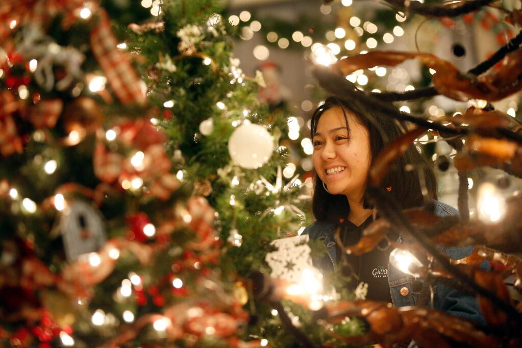 Casa Grande High School senior Sue Jacob shares a laugh with another judge while they select the best Christmas trees decorated by local businesses which will be sold to support charitable causes by the Fabulous Women of Petaluma, during the Festival of Trees at Hotel Petaluma in Petaluma, California, on Friday, November 30, 2018. (Alvin Jornada / The Press Democrat)