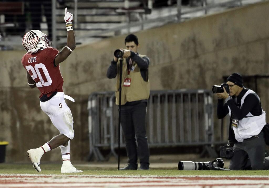 Stanford running back Bryce Love, left, celebrates after scoring a rushing touchdown against Cal during the second half Saturday, Nov. 18, 2017, in Stanford, Calif. (AP Photo/Marcio Jose Sanchez)