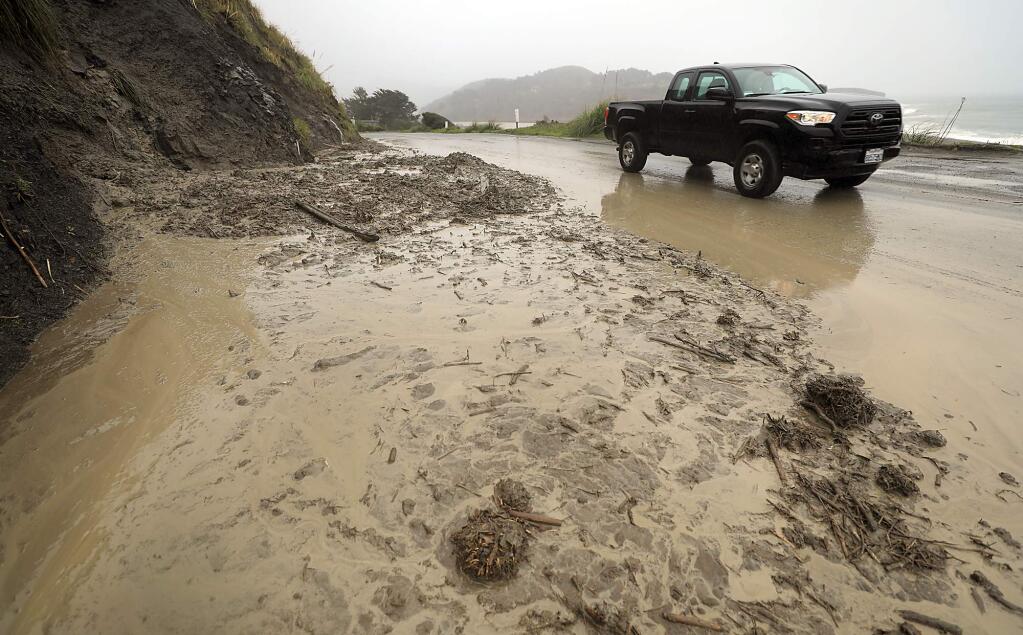 Mud and debris covers the north bound lane of HWY. 1, north of Jenner, Tuesday, Feb. 13, 2019. (Kent Porter / The Press Democrat) 2019