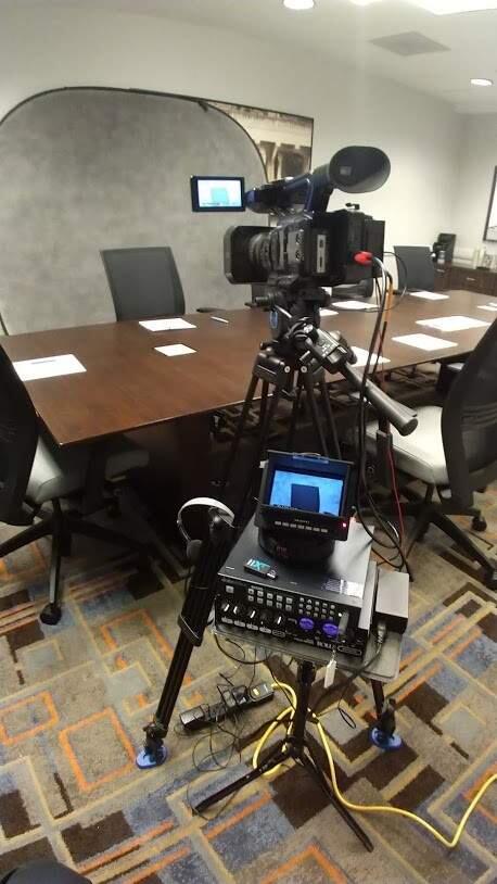 Videographers working with court reporting services have been forced to practice social distancing in getting sworn testimony like depositions in different rooms. Pictured is a setup in a law firm. (Photo by Mike Tunick)
