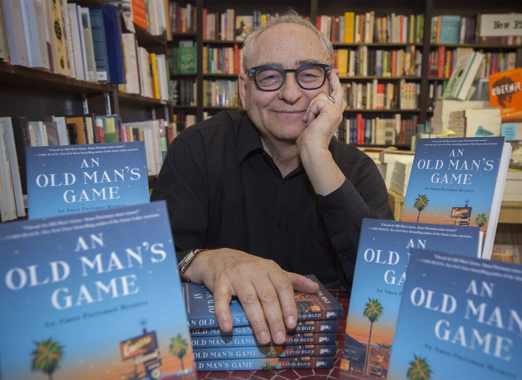 Andy Weinberger, proprietor of Readers Books on East Napa St., with his newly published book 'An Old Man's Game.' (Photo by Robbi Pengelly/Index-Tribune)