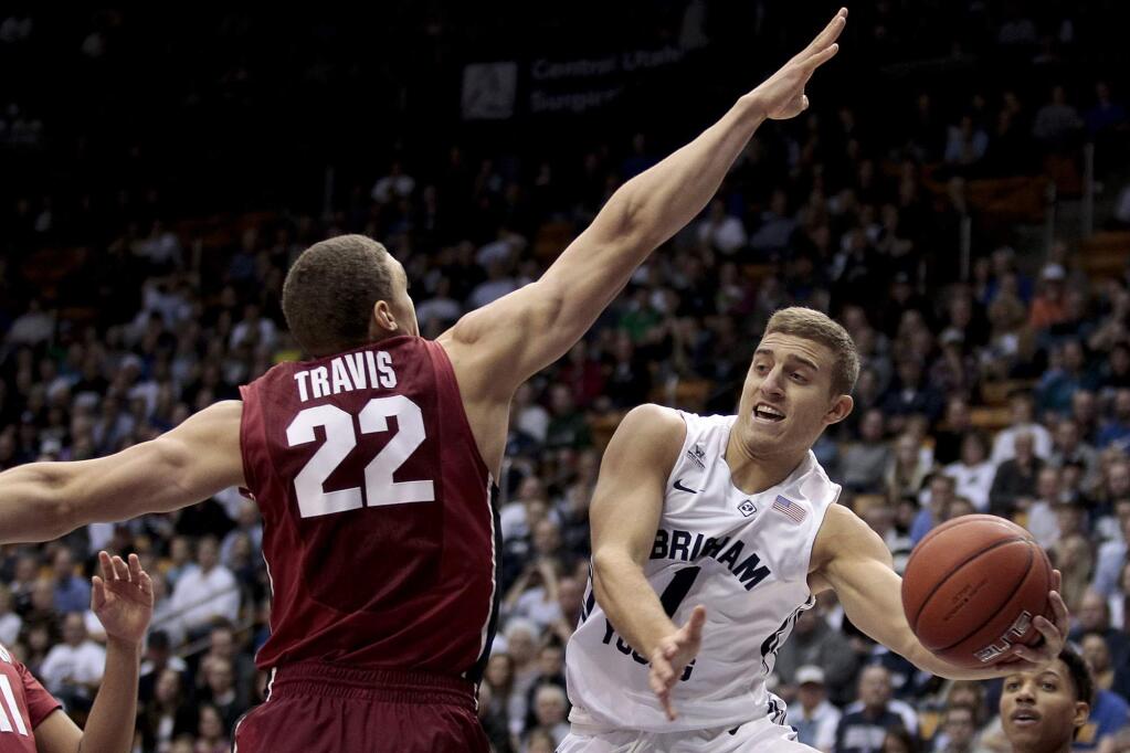 BYU guard Chase Fischer (1) passes around Stanford forward Reid Travis (22) during a game Saturday, Dec. 20, 2014, in Provo, Utah. (AP Photo/Daily Herald, Ian Maule)