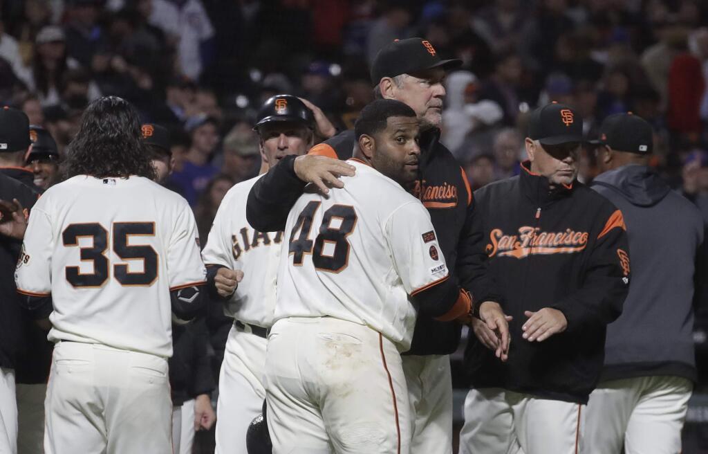 The San Francisco Giants' Pablo Sandoval hugs manager Bruce Bochy after hitting a solo home run against the Chicago Cubs during the 13th inning in San Francisco, Tuesday, July 23, 2019. (AP Photo/Jeff Chiu)