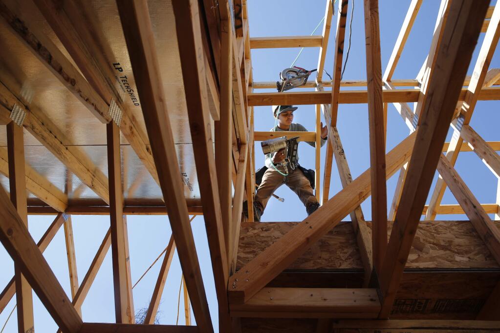 Fernando Garcia of R and R Framing works on a house being built by APM Homes in the Coffey Park area of Santa Rosa on Tuesday, June 26, 2018. (Beth Schlanker/ The Press Democrat)