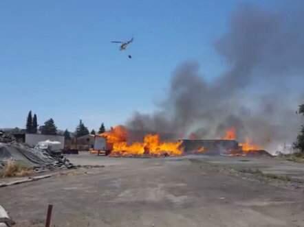 A helicopter helps fight the fire raging at a Schellville wooden pallet factory on Tuesday, June 5, 2018. (FACEBOOK LIVE/ SONOMA INDEX-TRIBUNE)