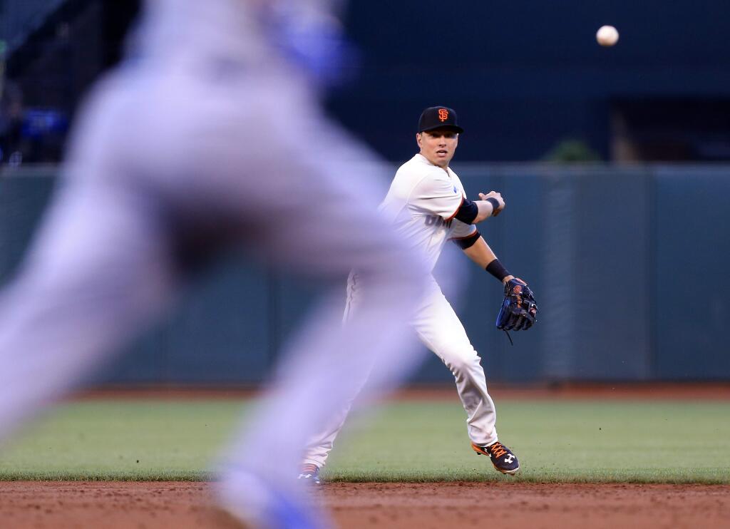 Joe Panik throws out Salvador Perez of the Royals during the Giants' 3-2 loss in Game 3 of the World Series in San Francisco, Friday Oct. 24, 2014. (Kent Porter / Press Democrat)