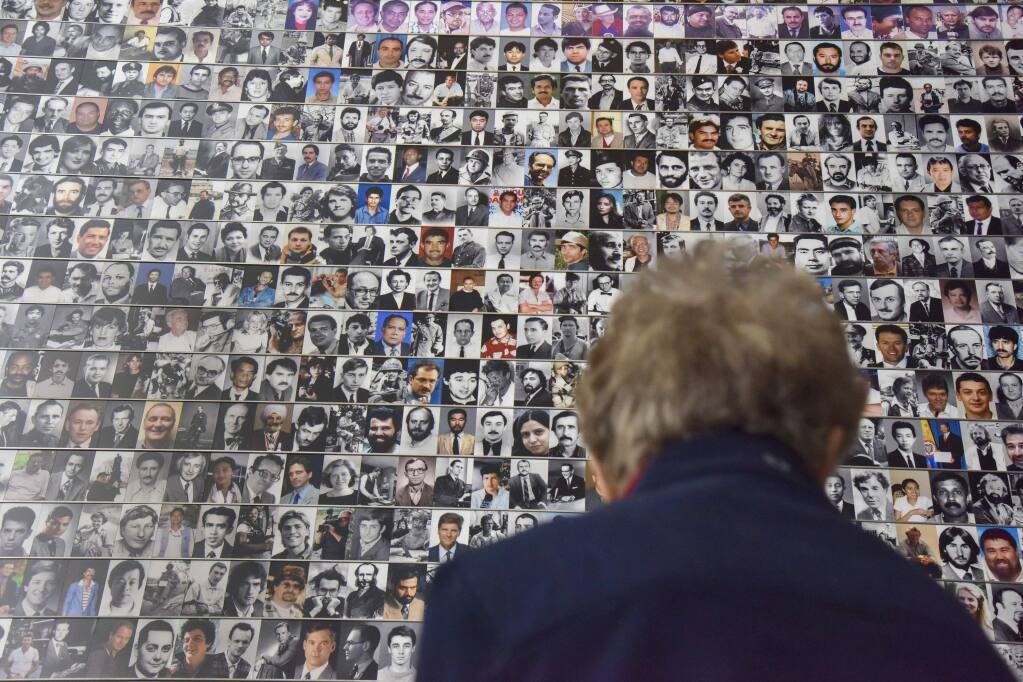 Photos of fallen journalists at the Newseum. (JAHI CHIKWENDIU / Washington Post)