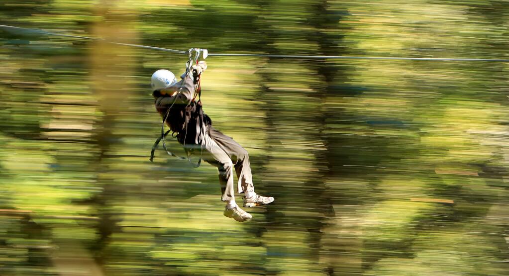 A customer of Alliance Redwoods Sonoma Canopy Tours uses the zip line, Wednesday March 28, 2018 near Camp Meeker, contributes to outdoor recreation companies employing over 4,500 workers which adds $731 million to the local economy. (Kent Porter / Press Democrat) 2018