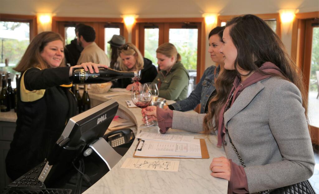 Will Bucquoy/for the Press Democrat).Toeby Gainey (left) poured wine for Emily Brown of San Francisco and Sarah Gallagher of Santa Rosa. The 26th Annual Winter WINEland featured over 100 wineries in Northern Sonoma County January 13th and 14th. Participants met winemakers, tasted limited production wines and new releases.