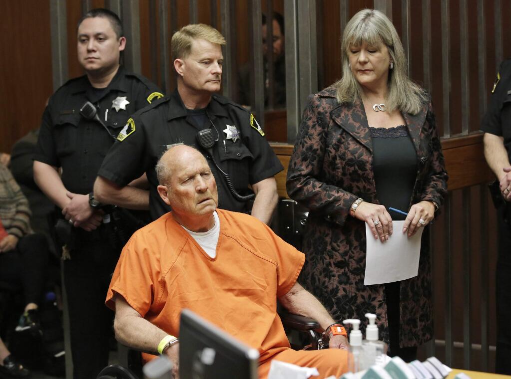 Joseph James DeAngelo, 72, who authorities suspect is the so-called Golden State Killer responsible for at least a dozen murders and 50 rapes in the 1970s and 80s, is accompanied by Sacramento County Public Defender Diane Howard, right, during his arraignment, Friday, April 27, 2018, in Sacramento County Superior Court in Sacramento, Calif. (AP Photo/Rich Pedroncelli)