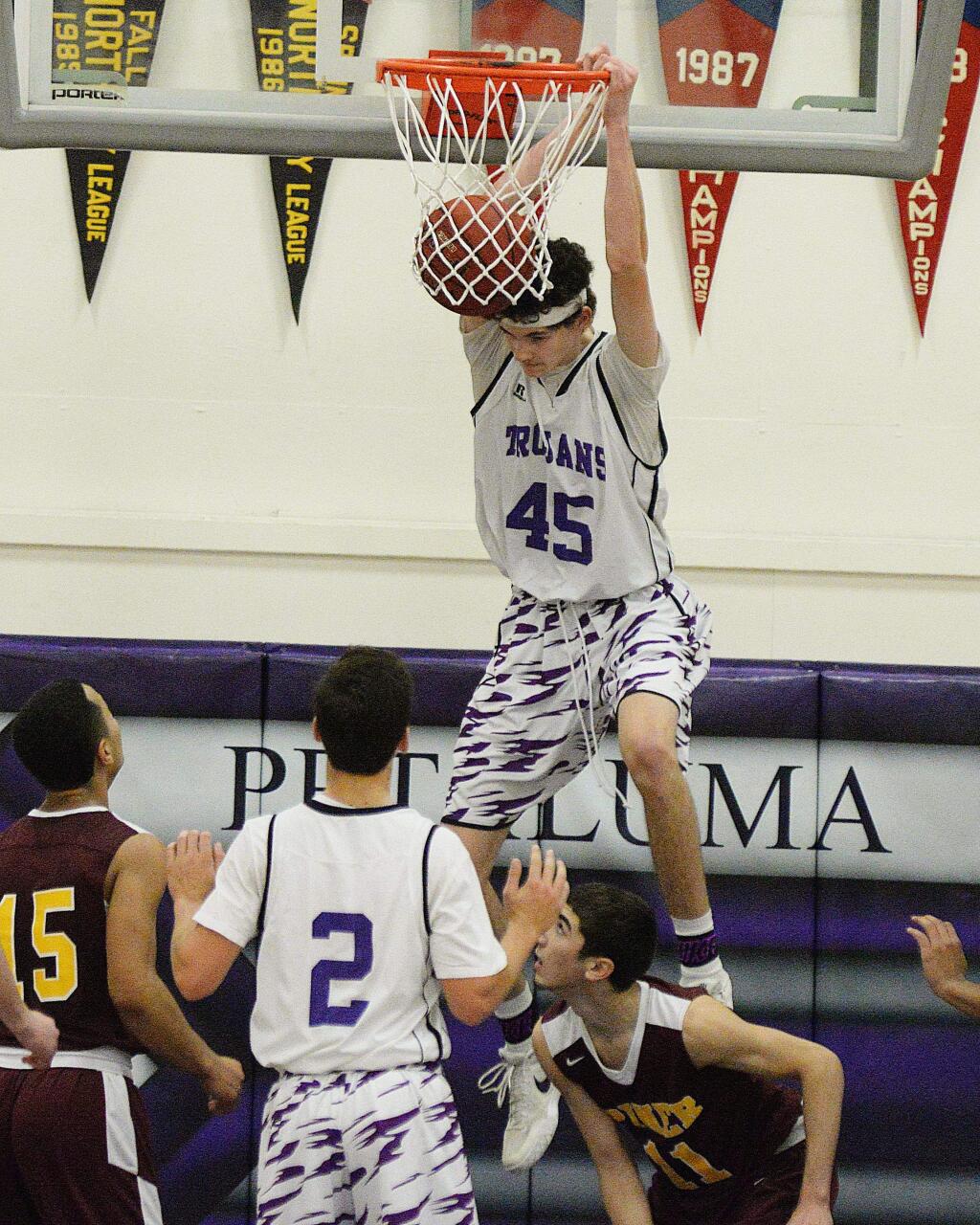 SUMNER FOWLER/FOR THE ARGUS-COURIERPetaluma's Joey Potts slams down two points in the Trojans' 57-41 victory.