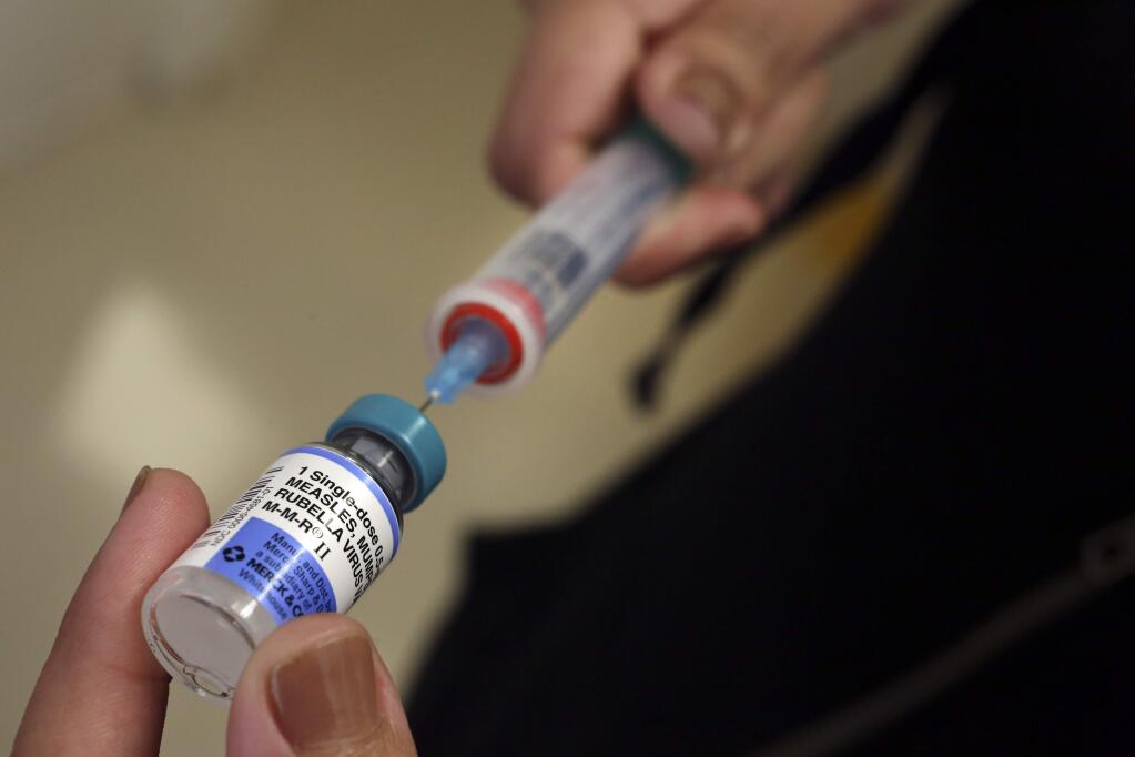 A vial containing the MMR vaccine is loaded into a syringe before being given to a baby at the Medical Arts Pediatric Med Group in Los Angeles. (MEL MELCON / Los Angeles Times, 2015)
