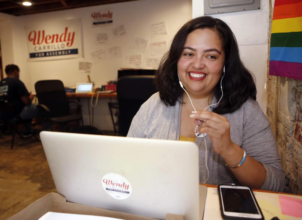 FILE - In this Sept. 29, 2017 file photo, Wendy Carrillo, then a candidate for California State Assembly District 51, calls voters at her campaign headquarters in Los Angeles. The leader of California's state Assembly on Friday, Feb. 7, 2020, formally reprimanded an assemblywoman and her chief of staff for inappropriate behavior, an unwanted hug and kiss from the assemblywoman and coarse sexual comments from her top aide. Assembly Speaker Anthony Rendon chastised Assemblywoman Wendy Carrillo, a fellow Democrat from the Los Angeles area, in the reprimand letters to her and chief of staff George Esparza. He ordered both to undergo training or coaching on appropriate workplace conduct. The letters are dated Thursday but were released Friday, along with a heavily redacted incident report. (AP Photo/Damian Dovarganes)