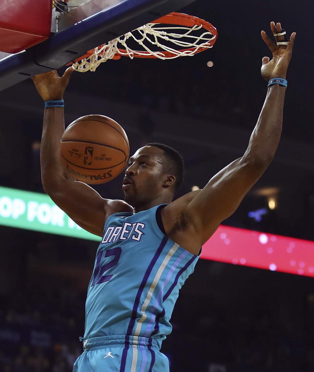 Charlotte Hornets' Dwight Howard scores against the Golden State Warriors during the first half of an NBA basketball game Friday, Dec. 29, 2017, in Oakland, Calif. (AP Photo/Ben Margot)